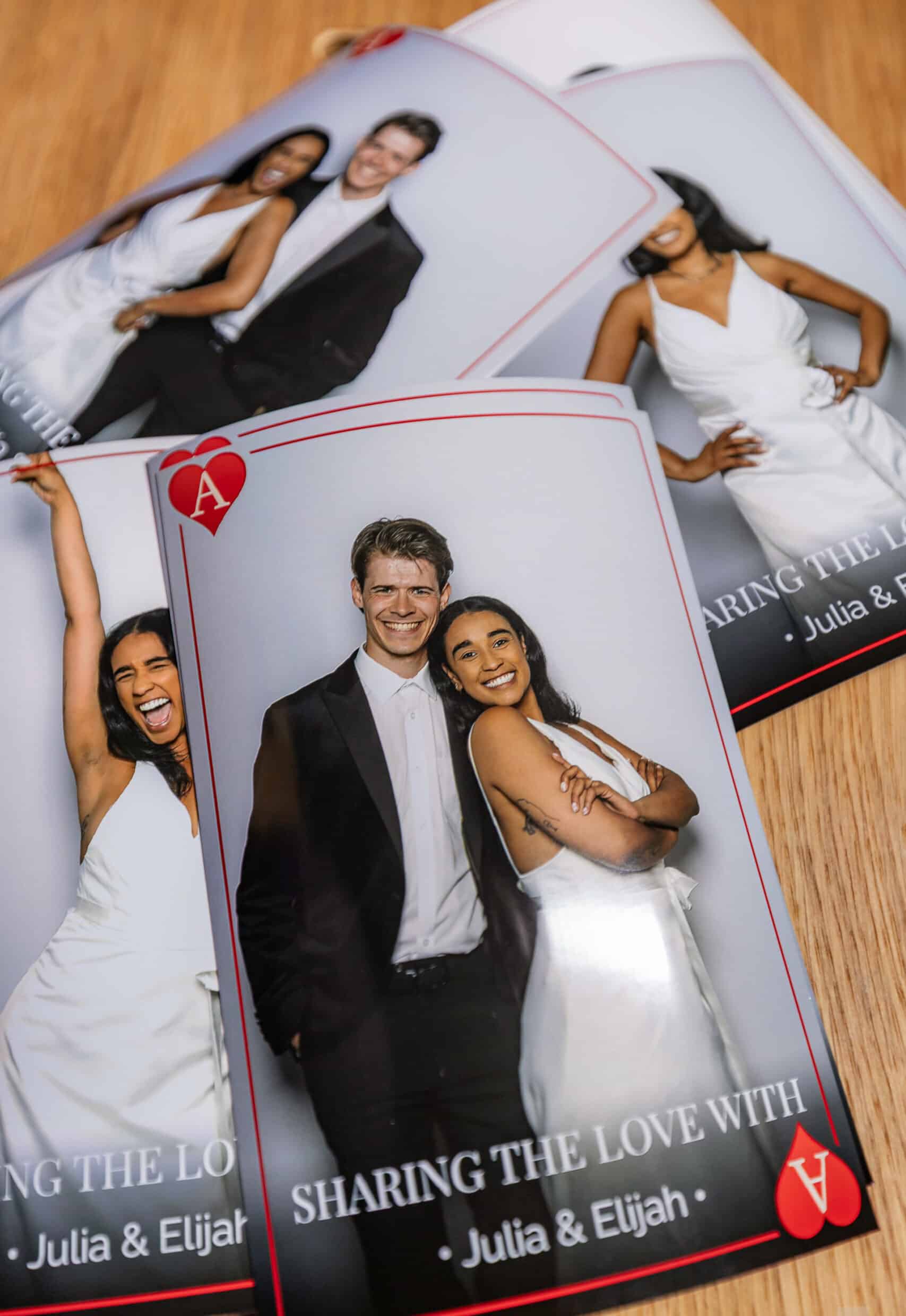 Wedding photo booth prints featuring joyful couple Julia and Elijah, showcasing elegant attire and playful expressions, capturing memorable moments from their celebration.