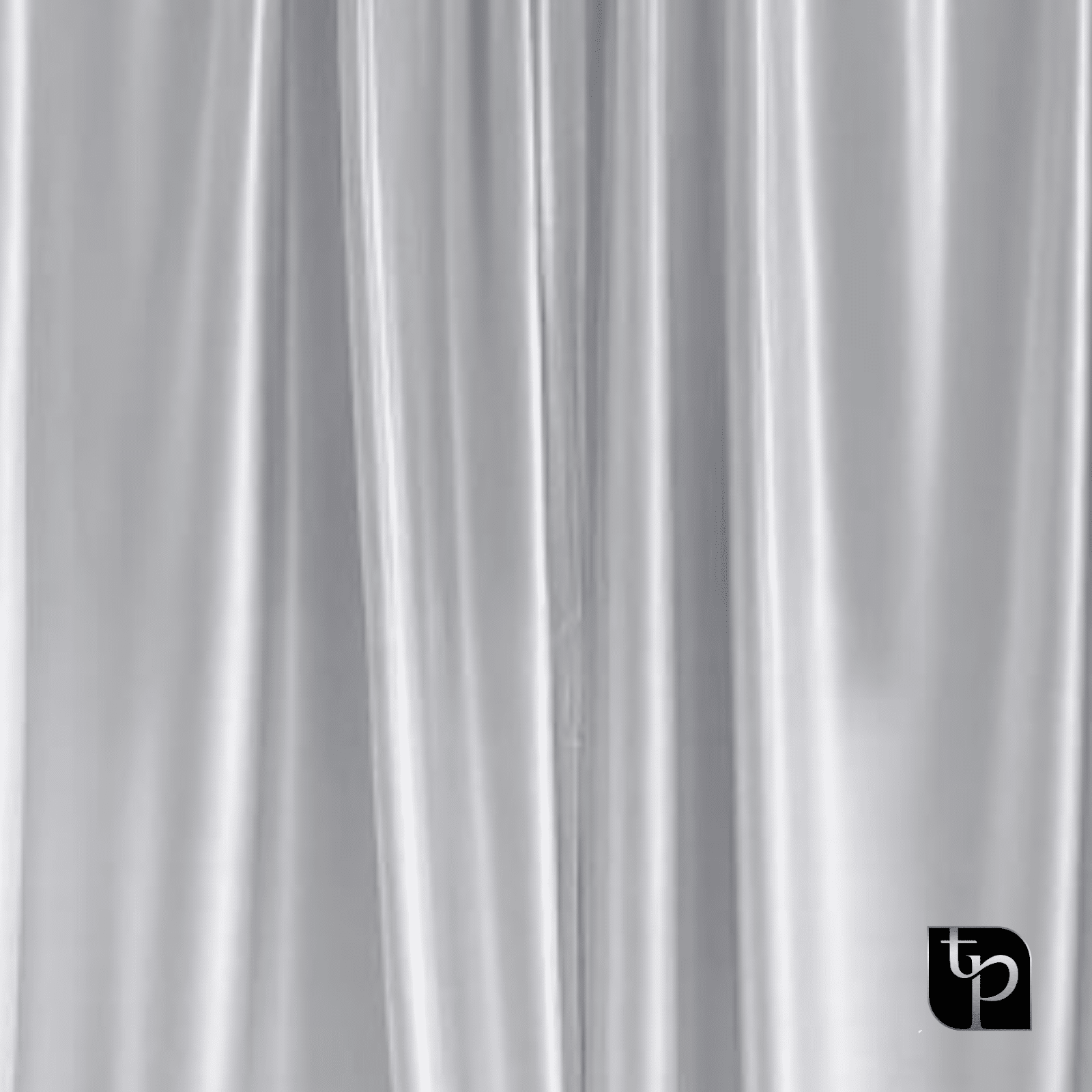 Silky silver backdrop fabric with soft folds, ideal for enhancing photography settings, featuring The Phototique logo in the corner.