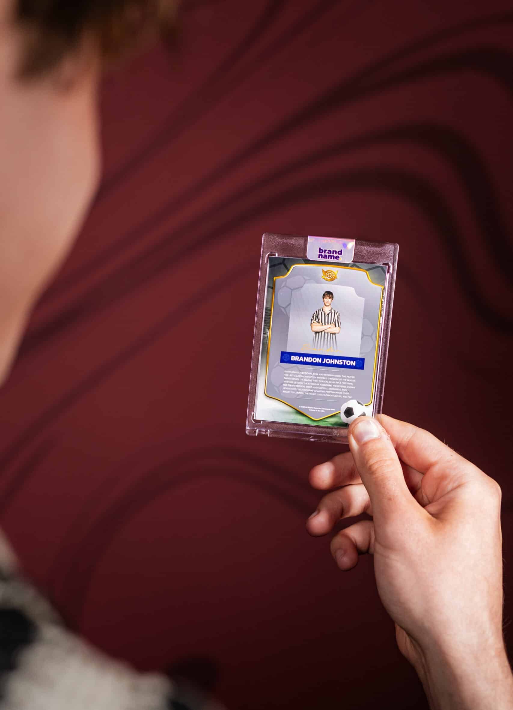 A group of people at a corporate event or party, with a photo booth setup in a professional-looking space.