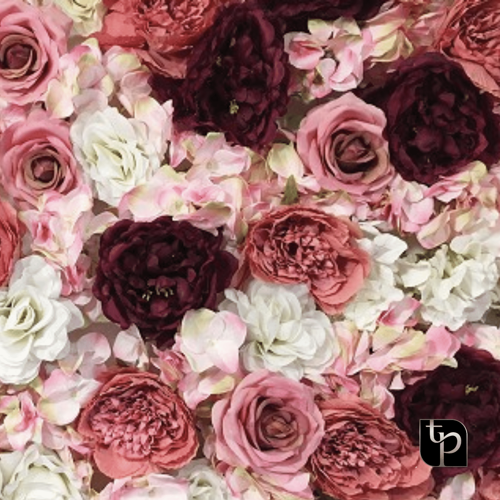 Floral backdrop featuring a mix of pink, white, and burgundy artificial flowers, ideal for enhancing photography settings.
