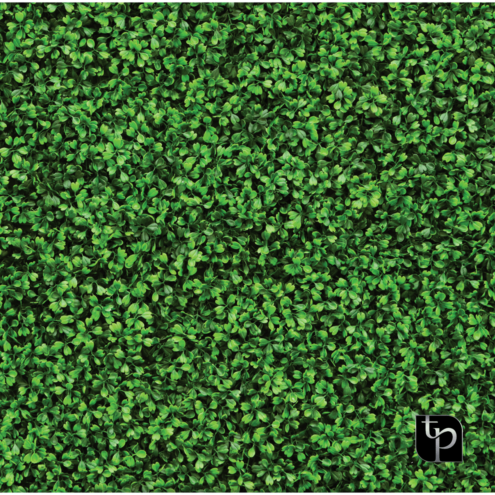 Artificial green foliage backdrop featuring dense leaves, ideal for enhancing photography settings, branded with The Phototique logo.