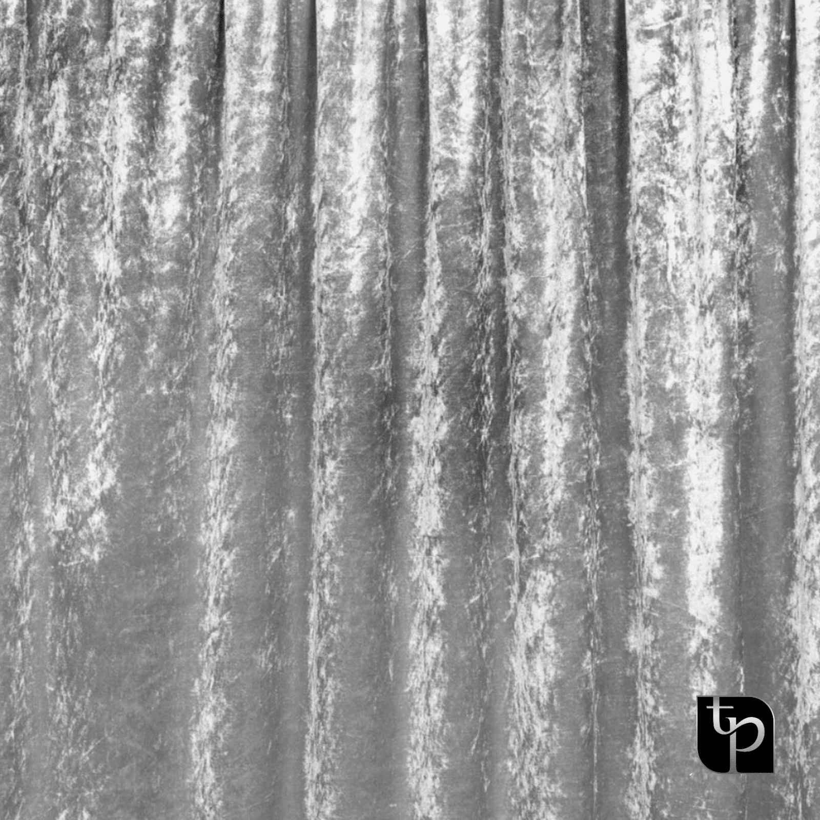 Silver velvet backdrop with textured folds, ideal for enhancing photography settings, featuring The Phototique logo in the corner.