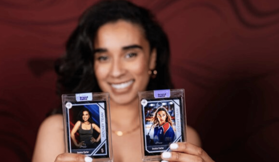 A screenshot showing a photo booth setup at a corporate event, with a branded backdrop and a line of people waiting to take a picture.