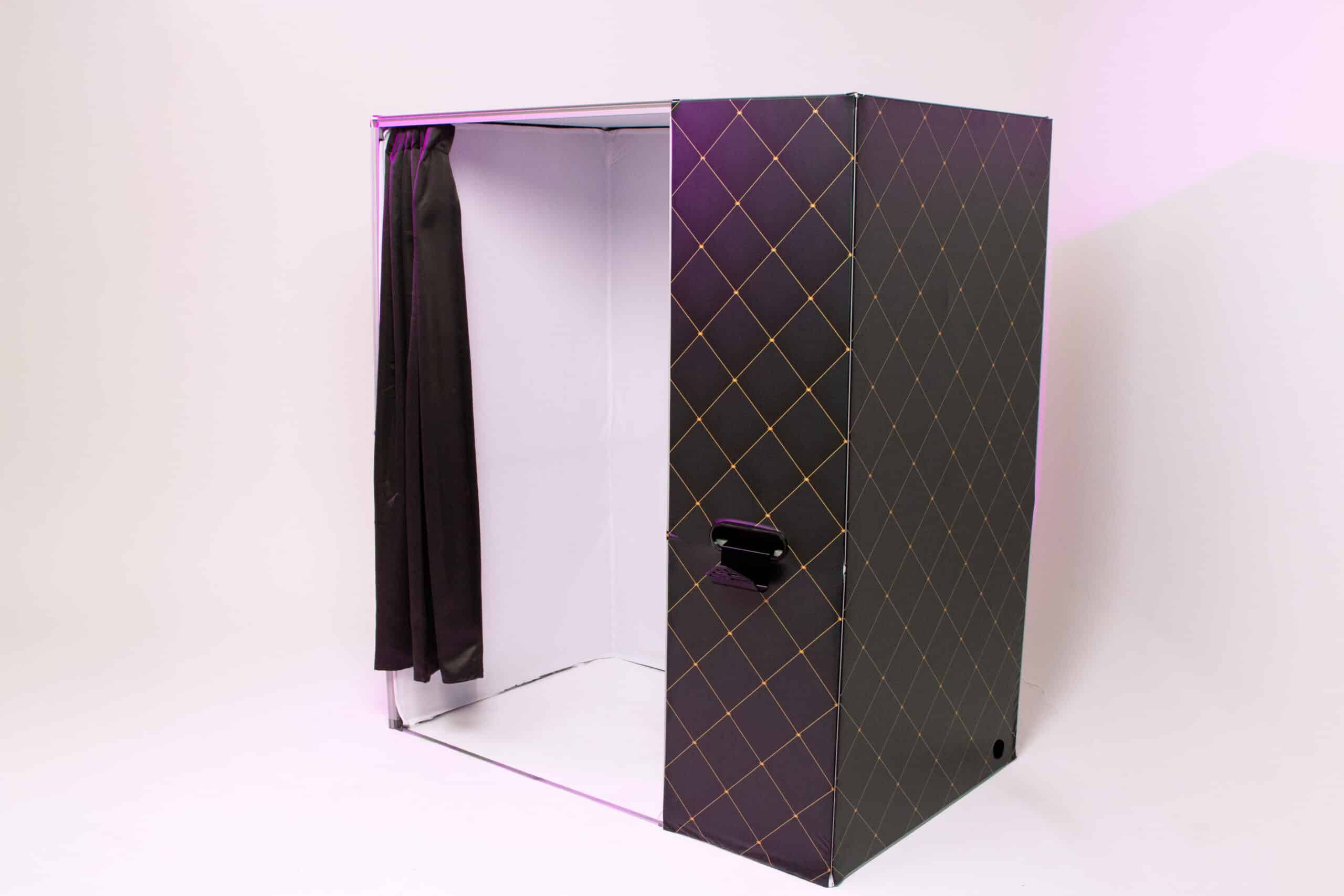 Enclosed photo booth with a modern design, featuring a black exterior with diamond patterns and a black curtain, ideal for private events and customizable branding.