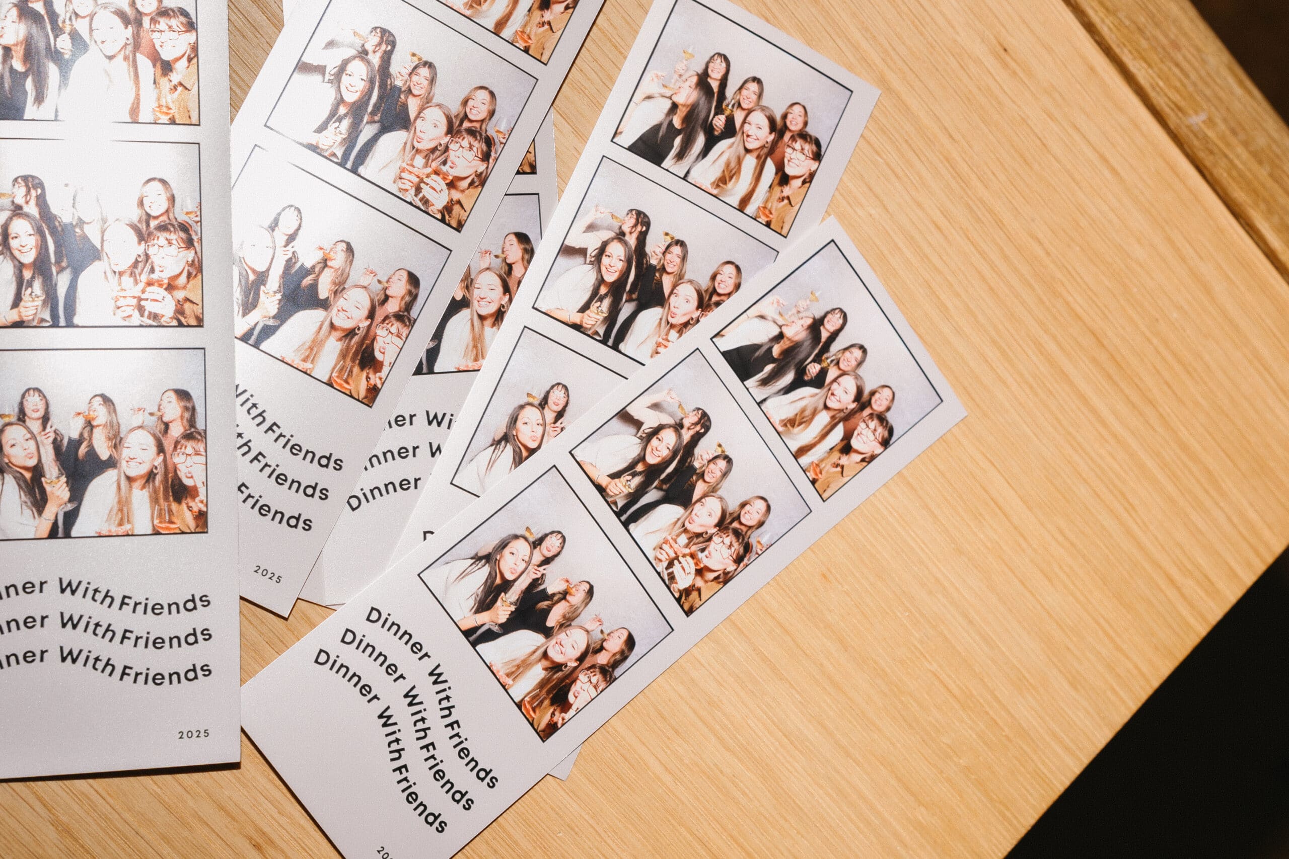 Photo booth prints featuring a group of friends posing joyfully, capturing memorable moments from a dinner event, with the text "Dinner With Friends" prominently displayed.