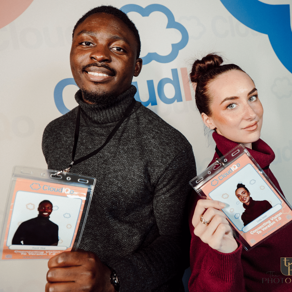 Two people show off their Lanyards from photo booth