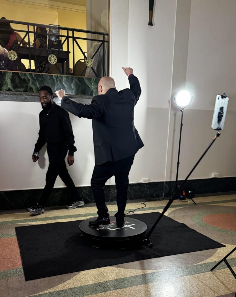 a Man dancing on the 360 photo booth platform enjoying himself at a DC Gala.