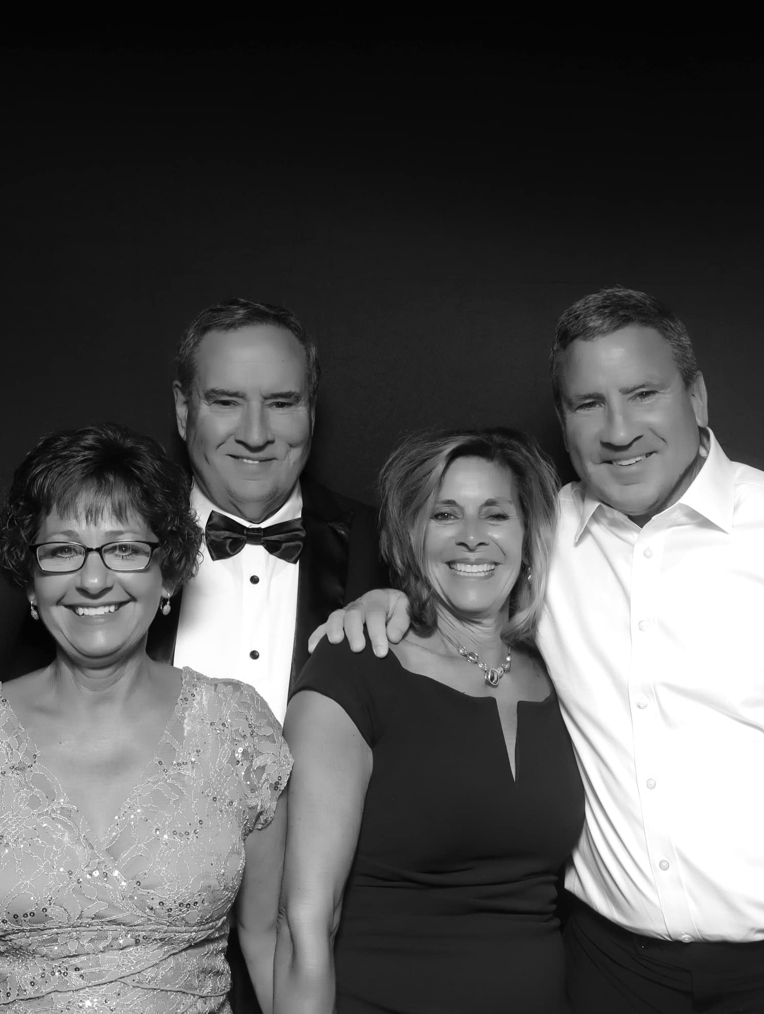 Family pose in a black and white photo with formal attire