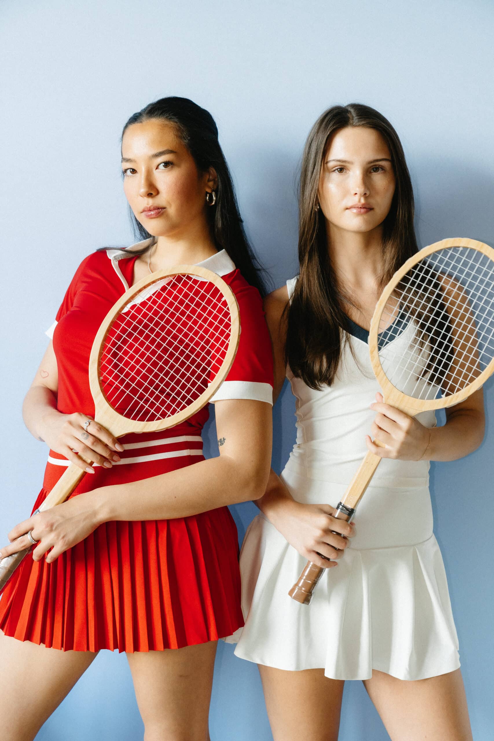 Ladies pose for photo booth tennis rackets