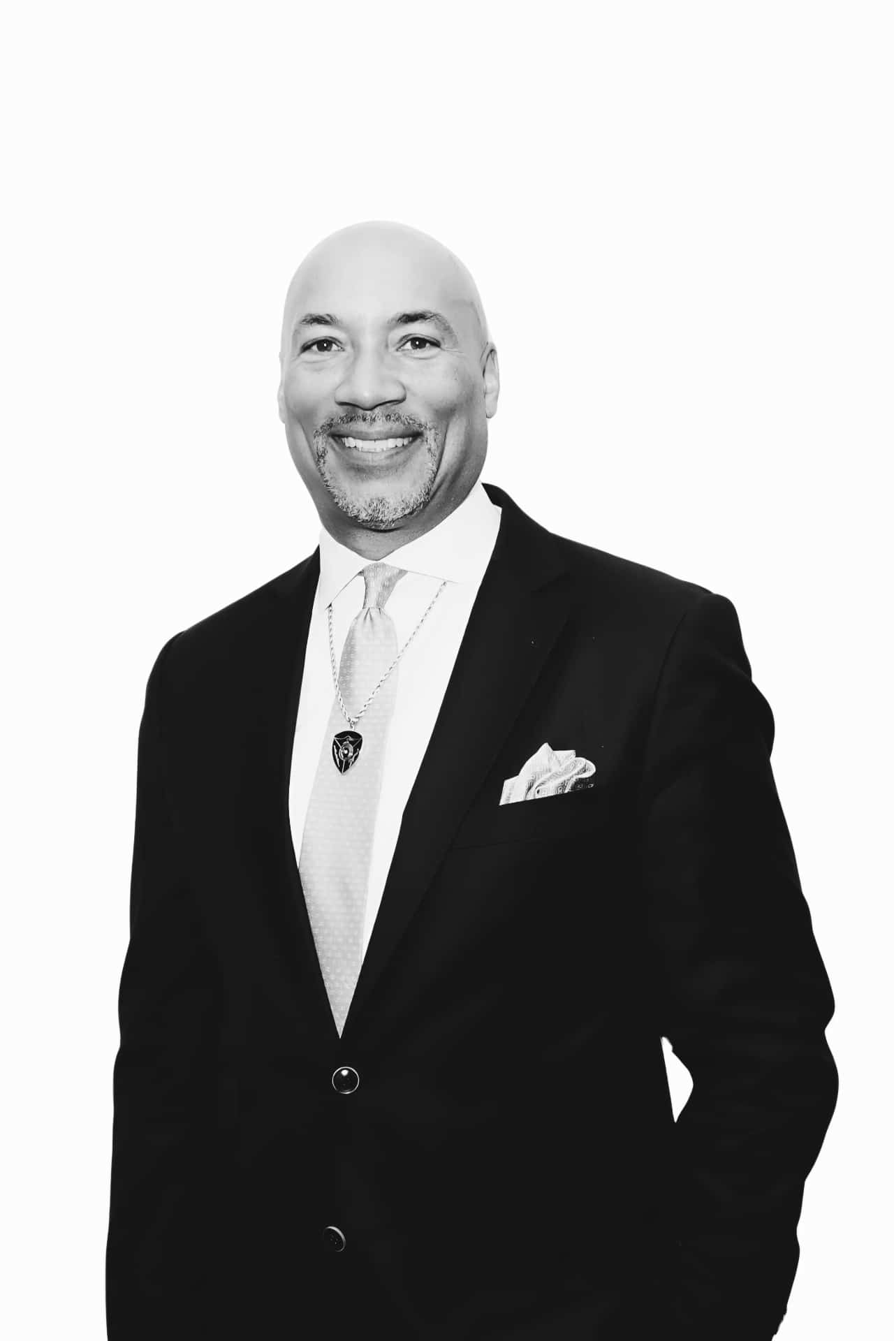 Man poses for photo booth black and white photo wearing a suit