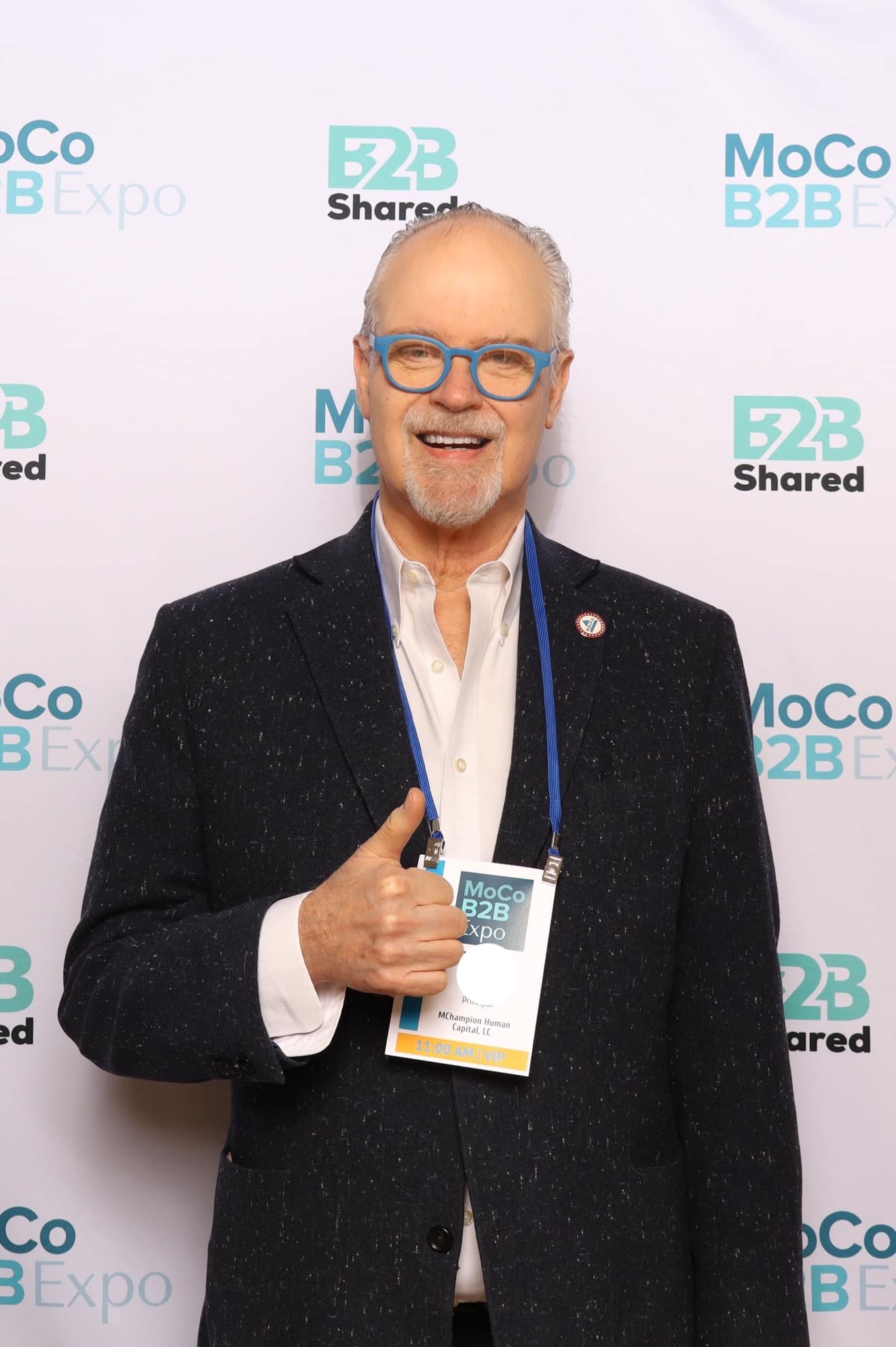 A business man stand in front of a branded photo booth