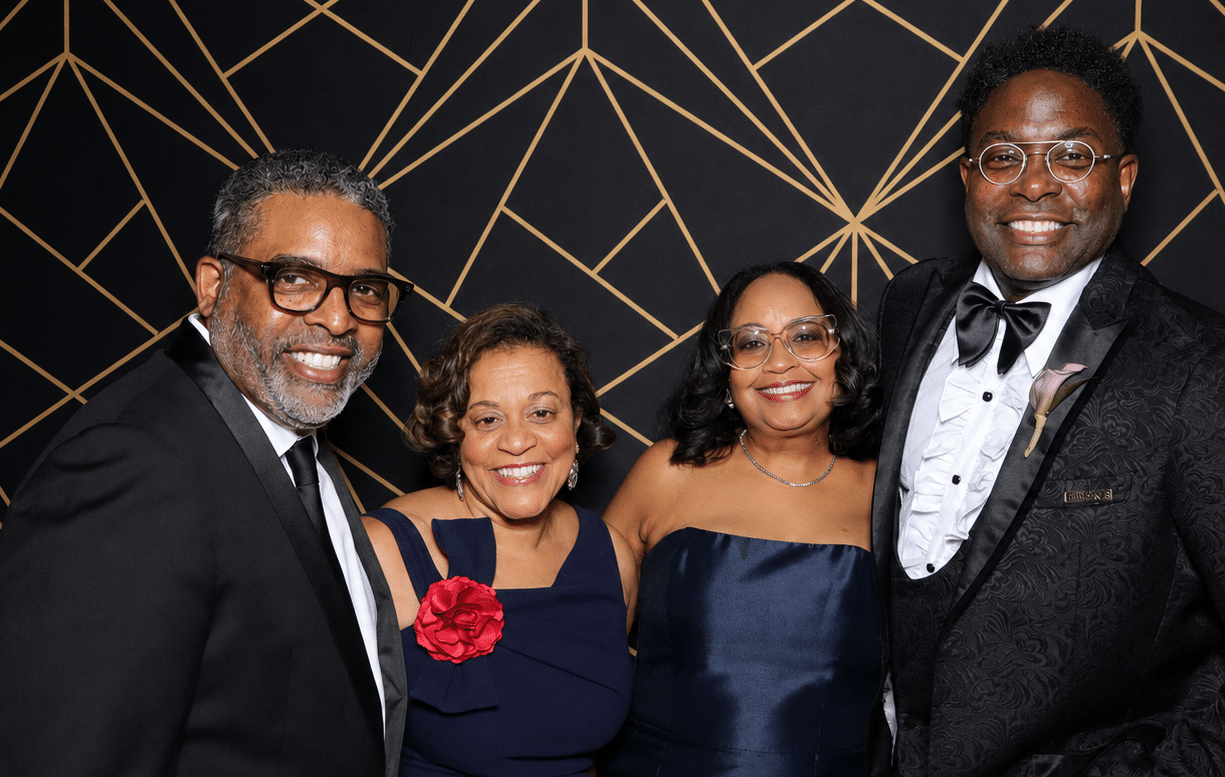 Group pose together for photo booth at a holiday gala