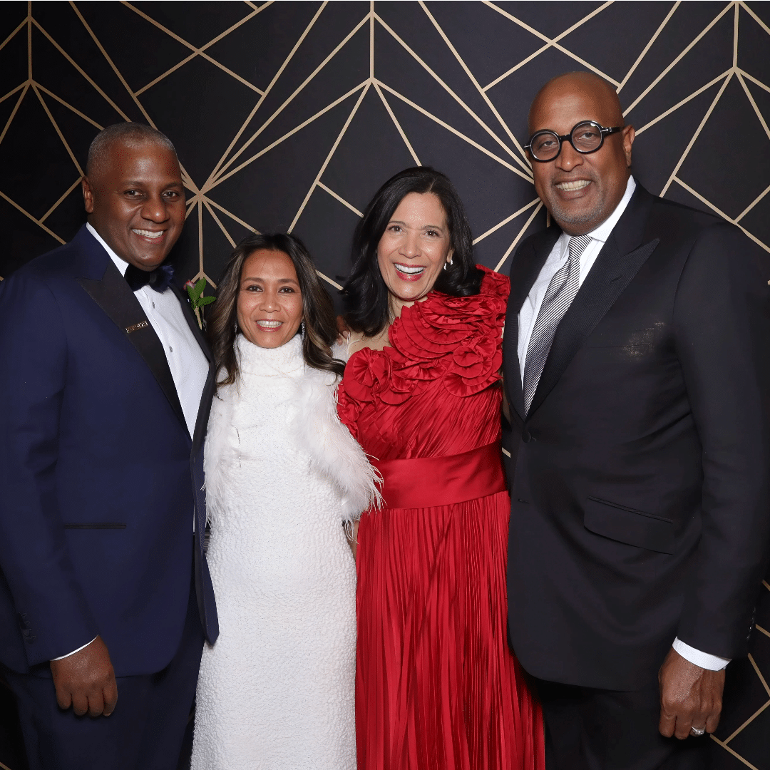 A well dressed group pose for photo booth at holiday gala at the Mayflower Hotel DC