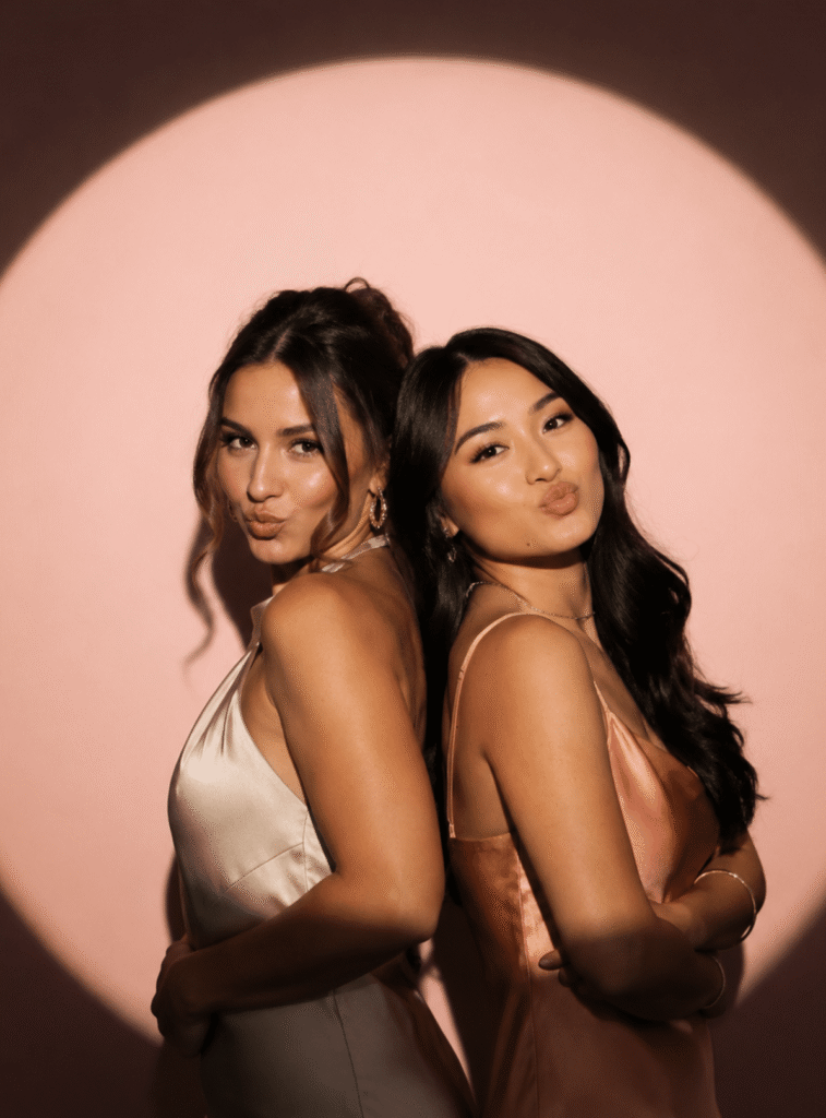 two women pose in the spotlight photo booth